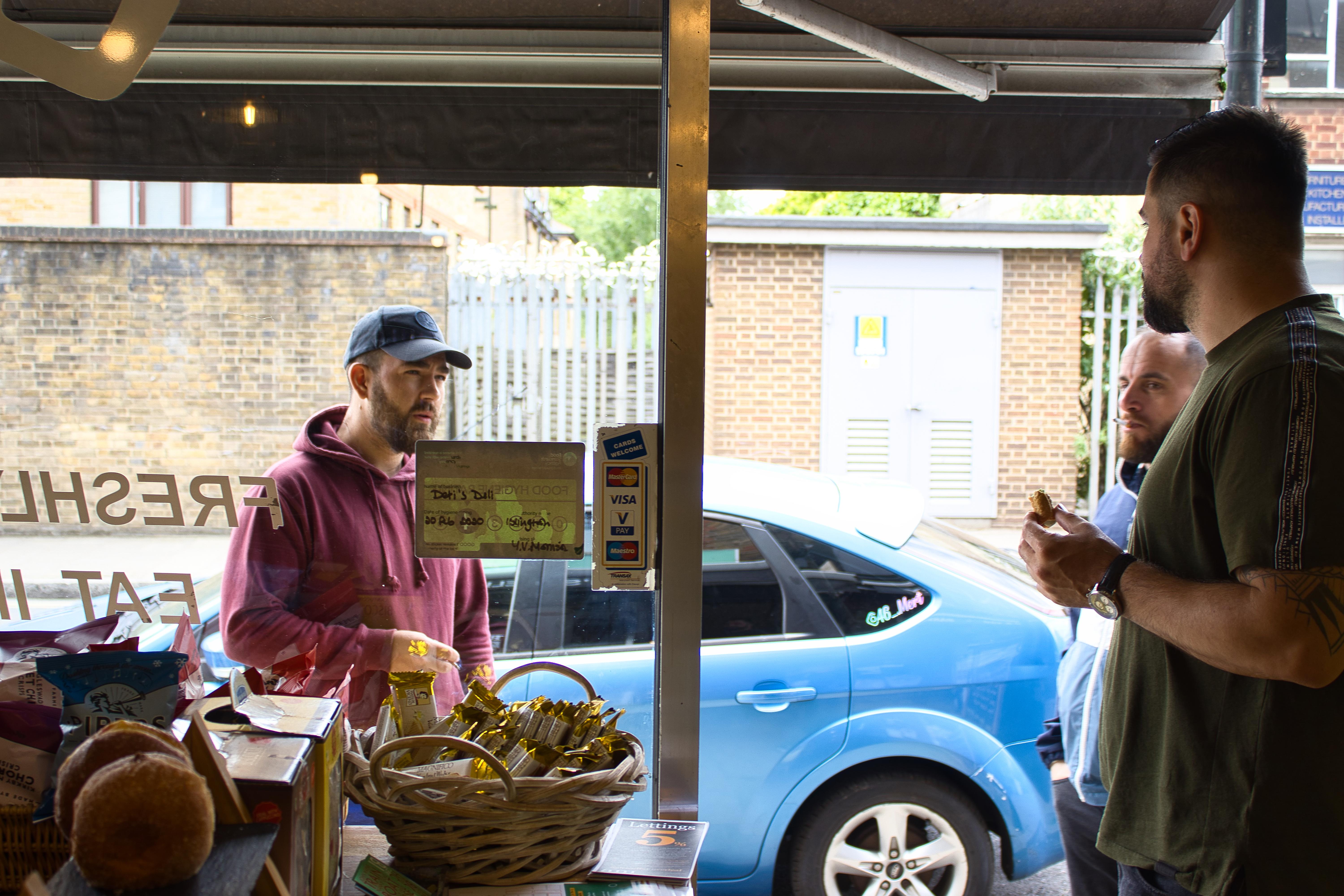 Two customers chatting at the entrance.