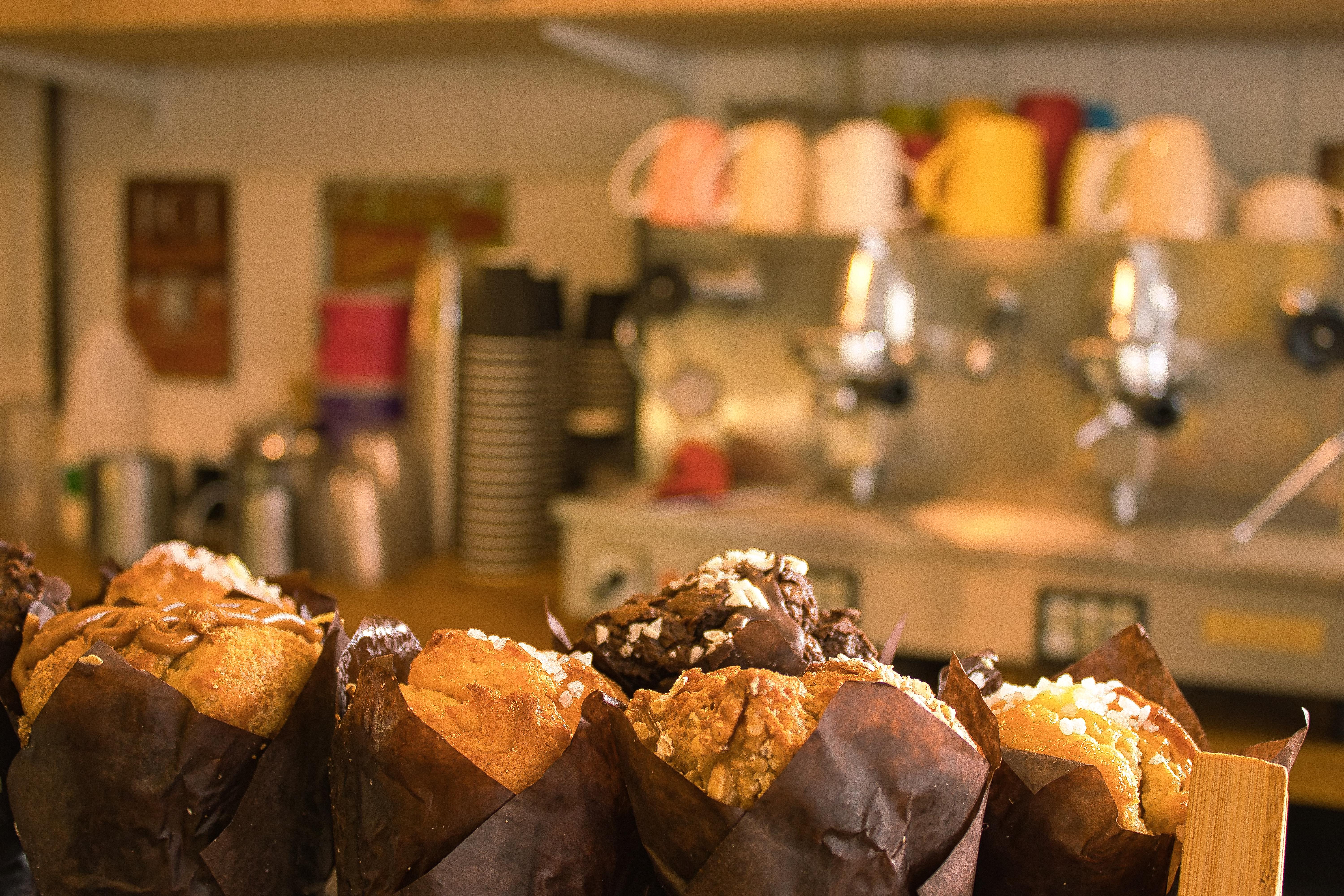 Delicious muffins with a coffee machine in the background.